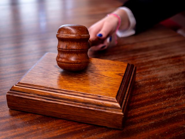 A judge's gavel resting on a wooden block