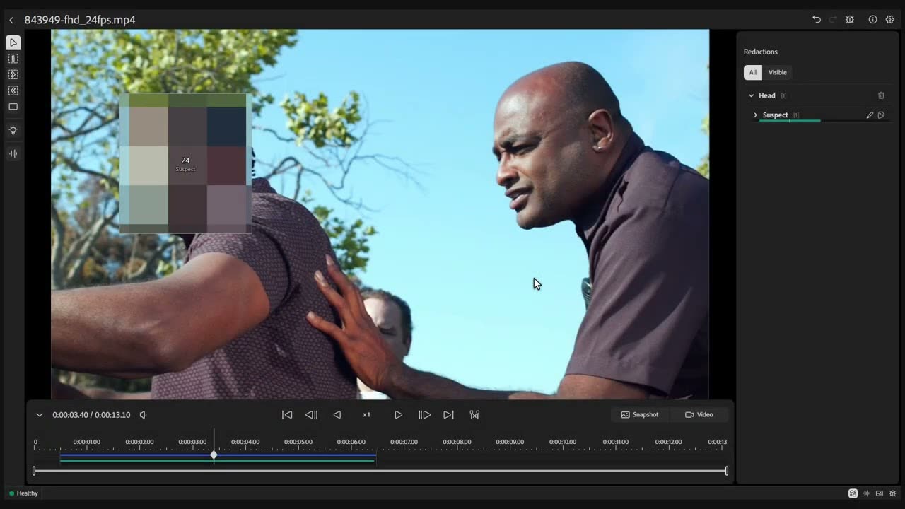VeloSCN Blenda masking a single head during a roadside arrest, the redaction labelled Suspect in the Redactions panel while the officer stays visible